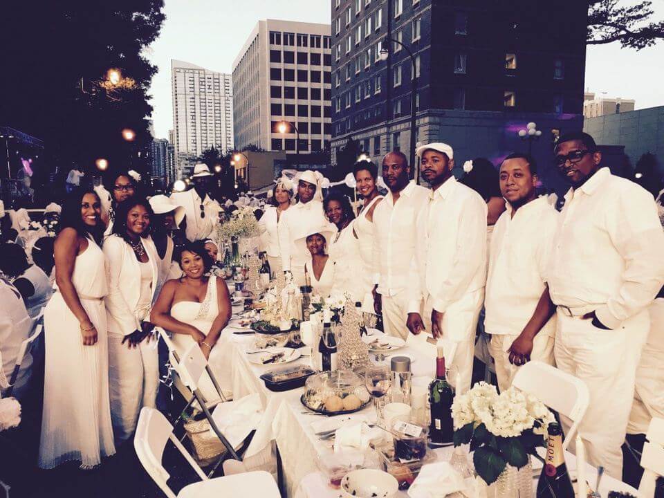 People Posing At the Table In White Clothes