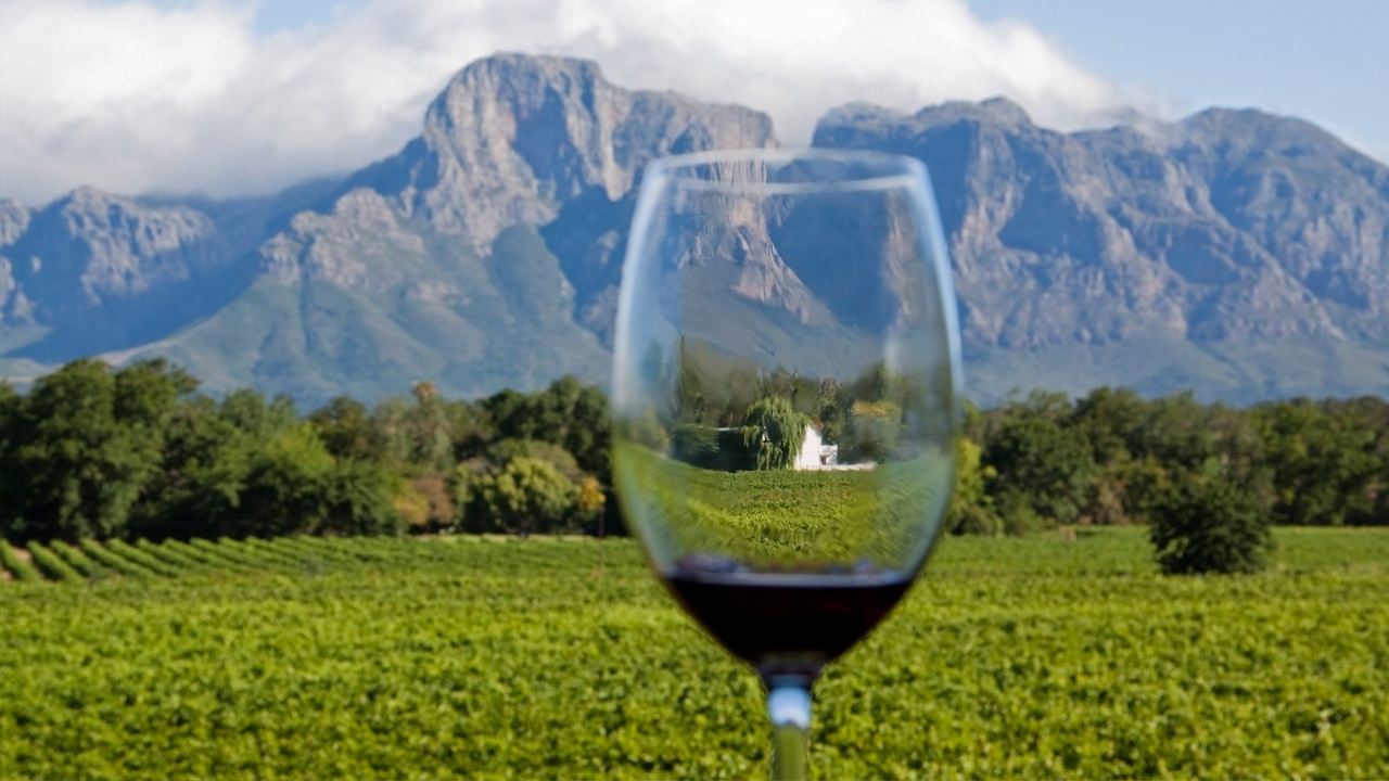 Picture of mountains with wine glass in foreground