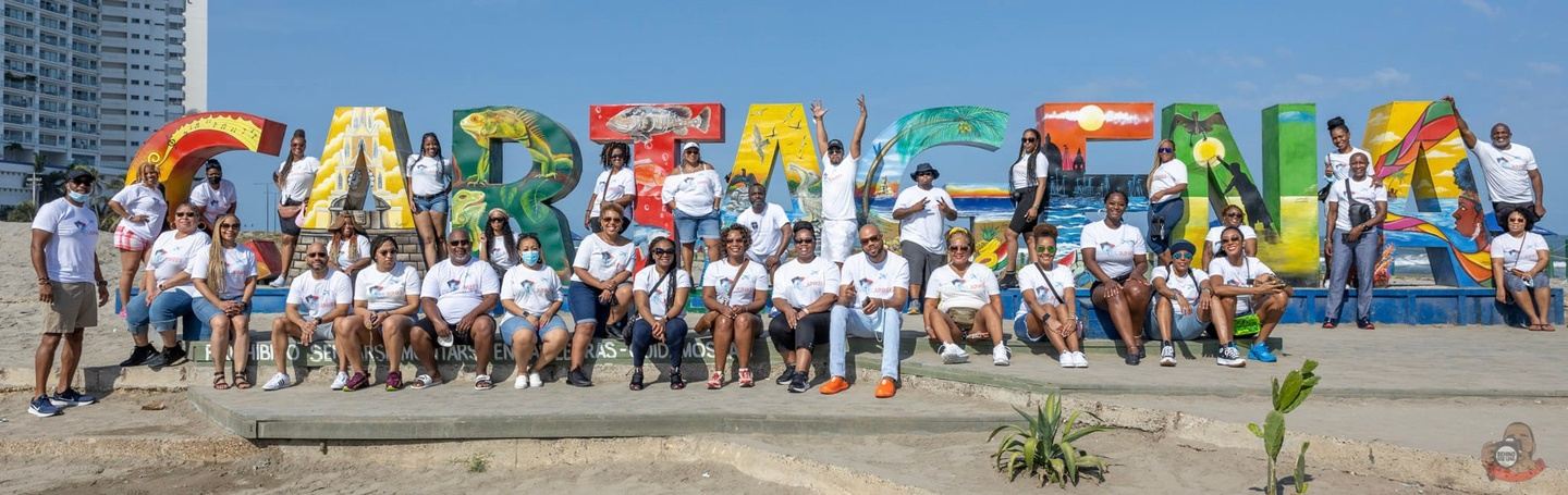 People Posing In Front of Cartagena Sign